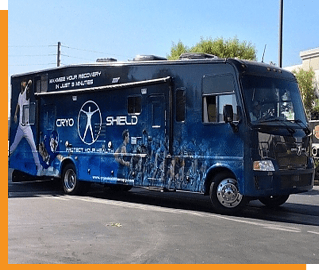 A blue bus parked in the street with graffiti on it.