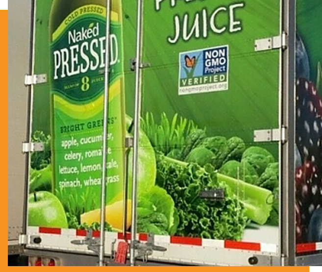 A truck with a green juice advertisement on it.