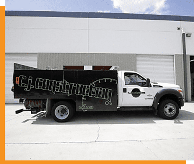 A white truck parked in front of a building.