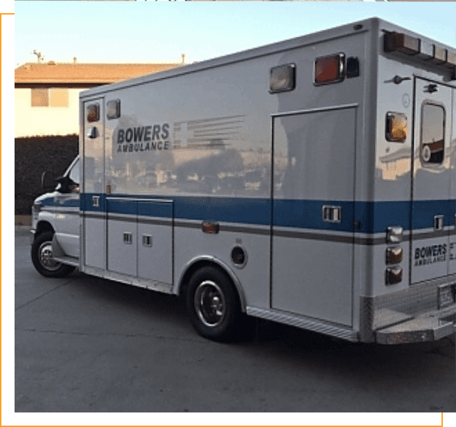 A white and blue ambulance parked in the street.